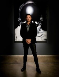 Photo of Philippe Hoerle-Guggenheim standing in a gallery
